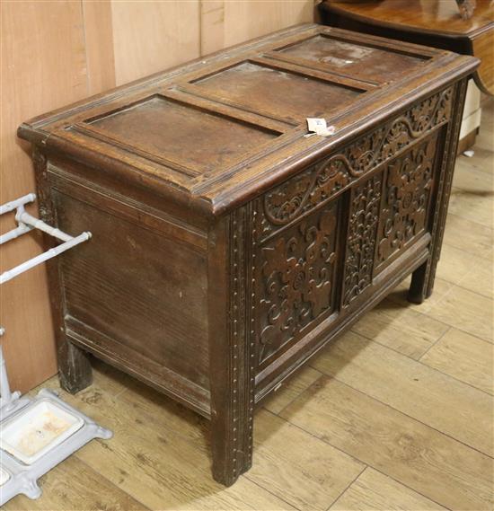 A carved oak coffer W.101cm